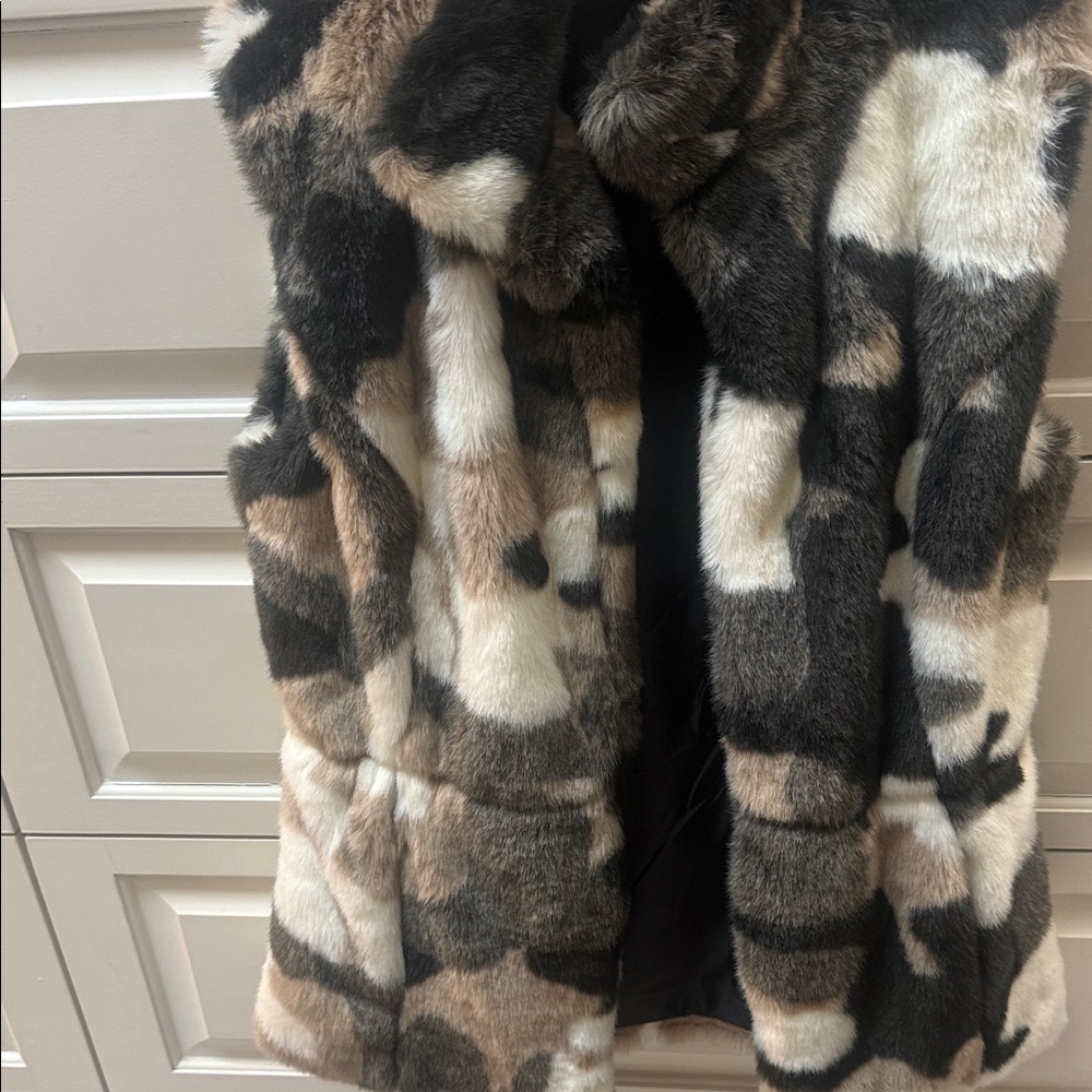 Furry vest in tan, black, grey and white